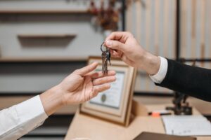 one person handing keys to another