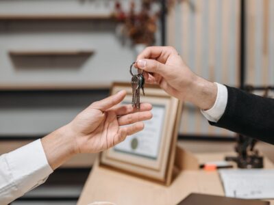 one person handing keys to another
